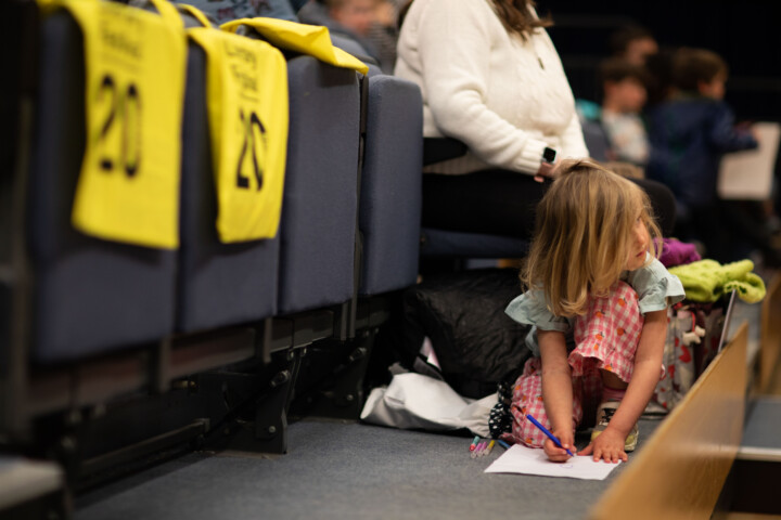 Litte girl drawing bags on seats