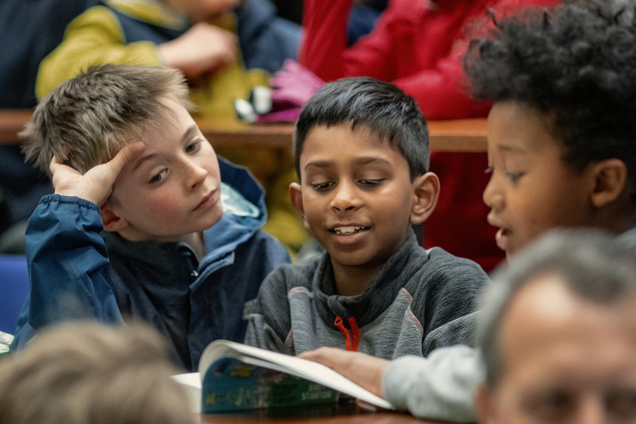 Three boys reading audience
