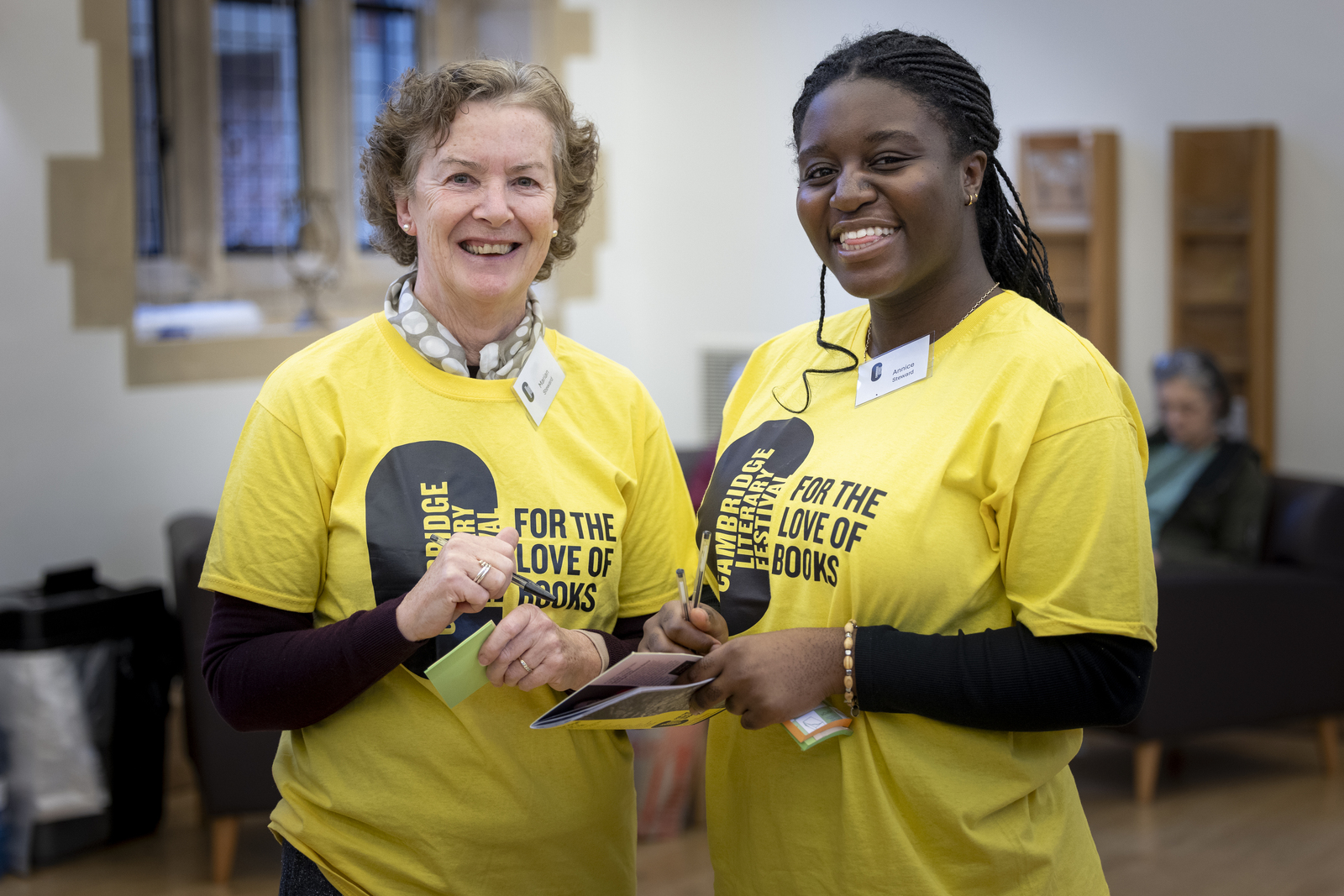 Two festival volunteers smiling at the camera at the Winter 2025 festival